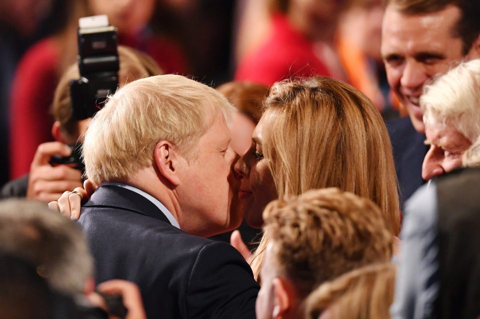  The Tory leader plants a kiss on his girlfriend Carrie's cheek following his keynote Conference speech in October