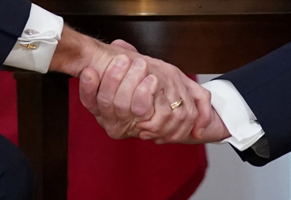  Shades of red - and white - show the pair's handshake wasn't exactly friendly