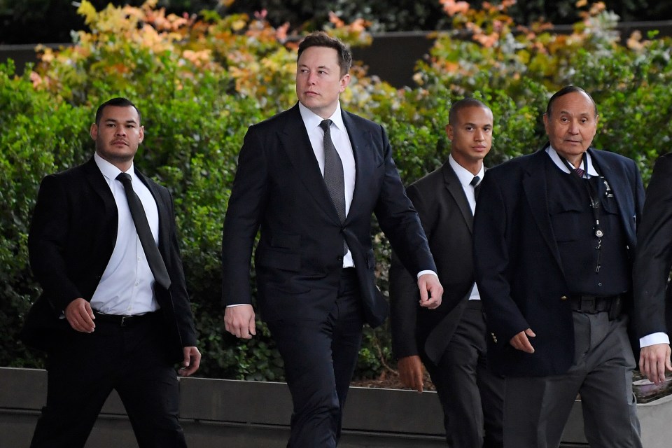  Tesla CEO Elon Musk, second from left, arrives at the US District Court in LA