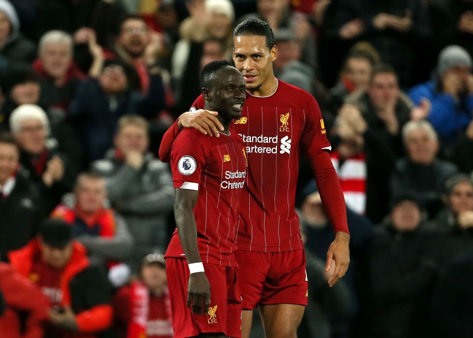 Mane celebrates with Virgil van Dijk as the pair but their Ballon d'Or pain behind them