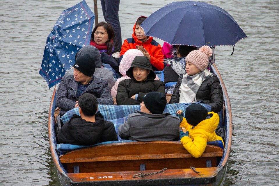  Tourists brave monsoon conditions in the River Cam in Cambridge on Tuesday