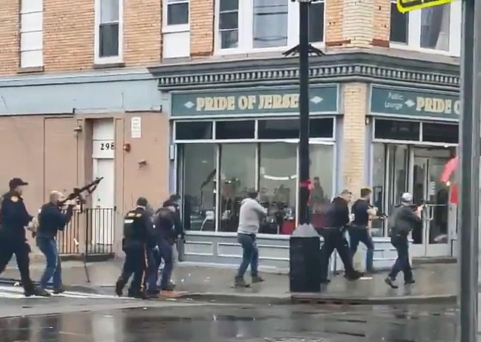  Armed cops moved in formation as they swarmed the scene of the supermarket shootout