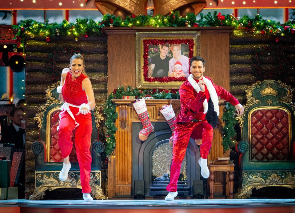  A family portrait is visible above the fireplace during their routine