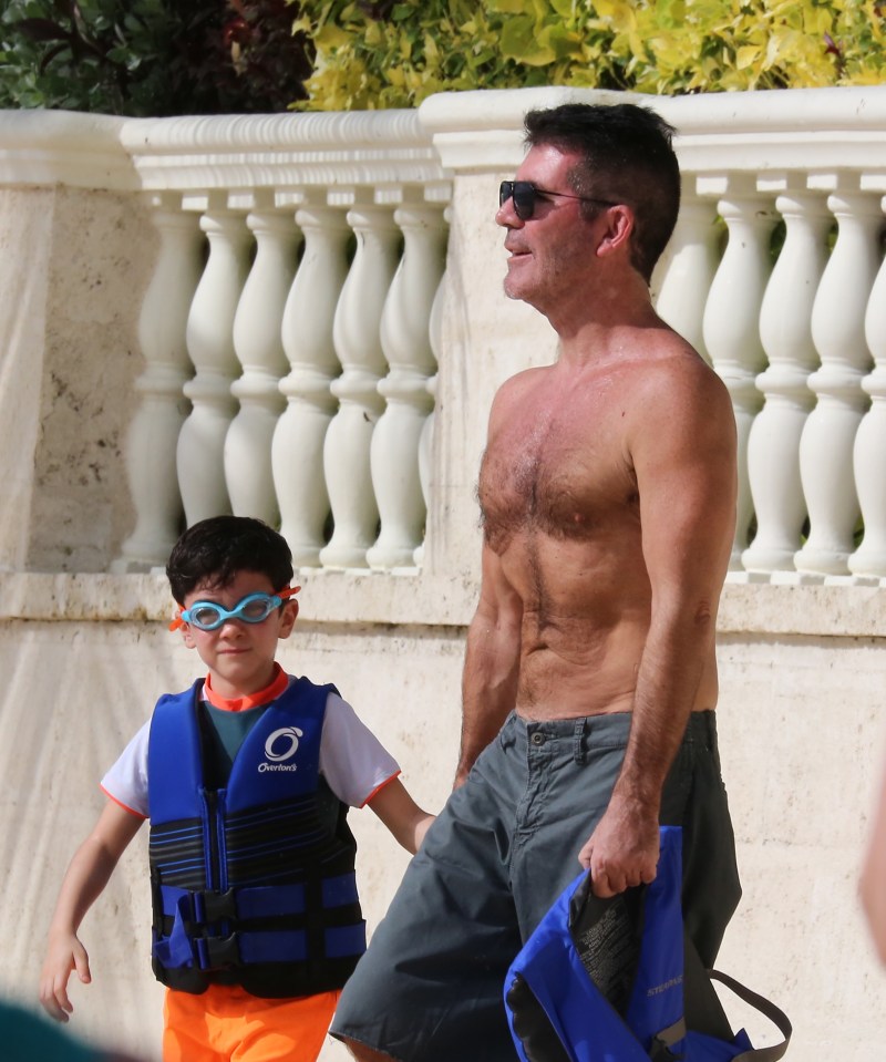  Simon looked slimmer than ever in Barbados today as he went for a swim with son Eric