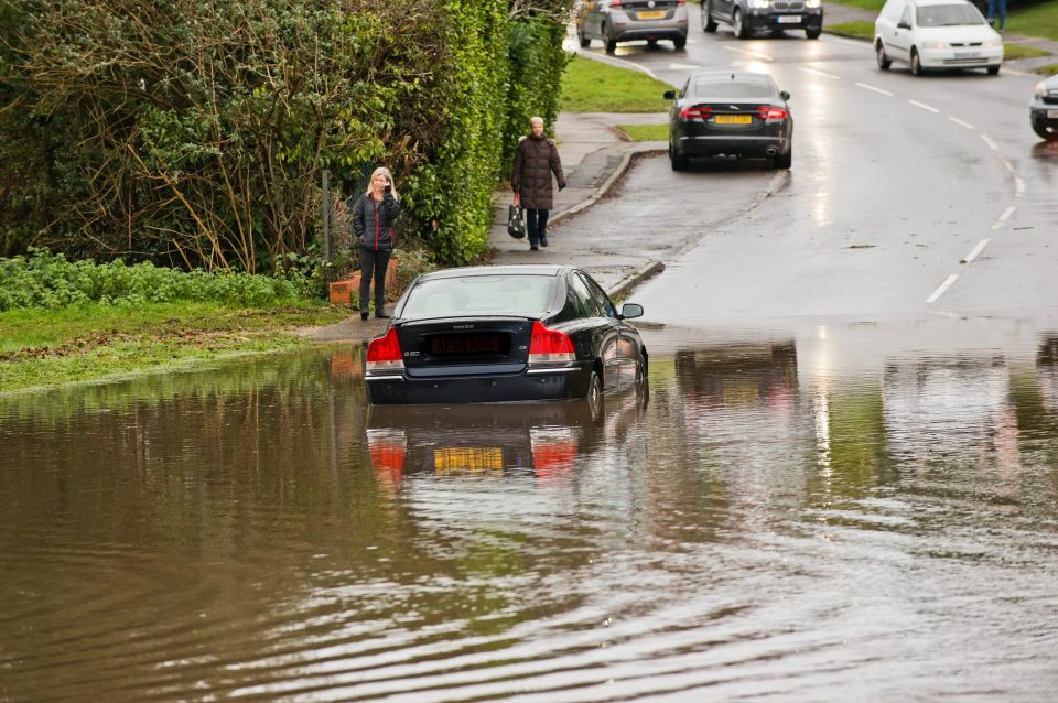  Emergency services at the scene of flooding on America Lane in Haywards Heath, Sussex, where a car become stranded