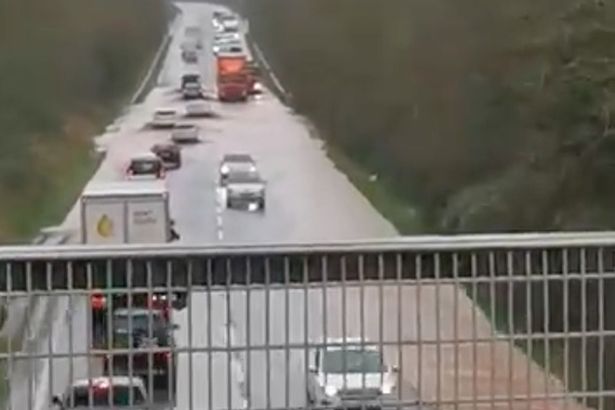  Cars struggle to navigate the A30 as torrential rain struck parts of Britain