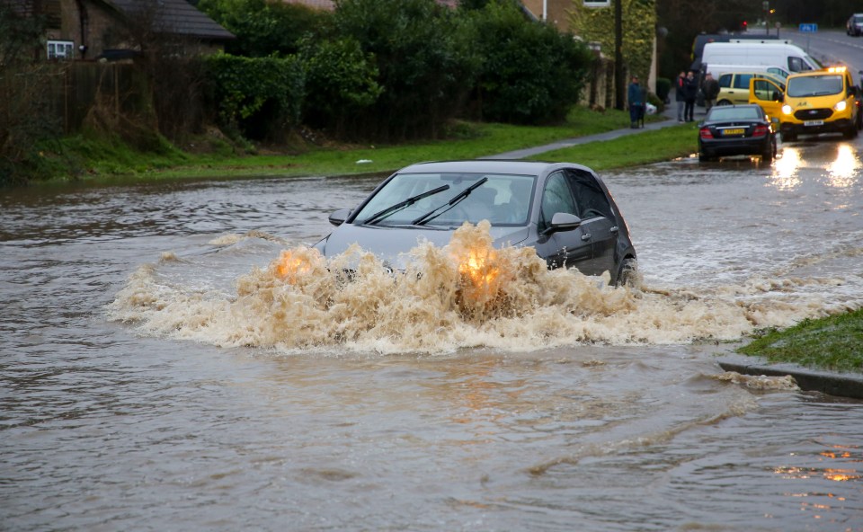  Cars plow through floodwater in Kent this morning after an overnight deluge