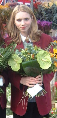  Amy as a teenager, with flowers for the Queen at a royal event