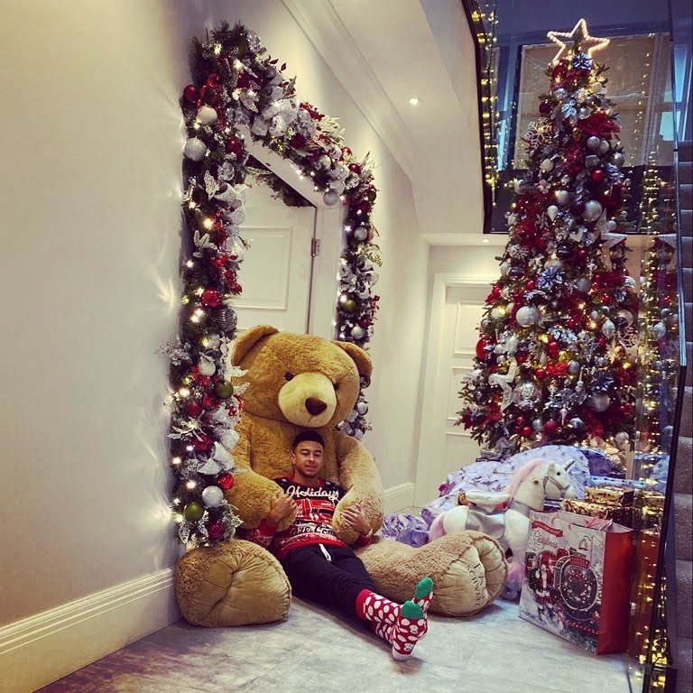  Jesse Lingard relaxes on a huge teddy bear as he celebrates Christmas