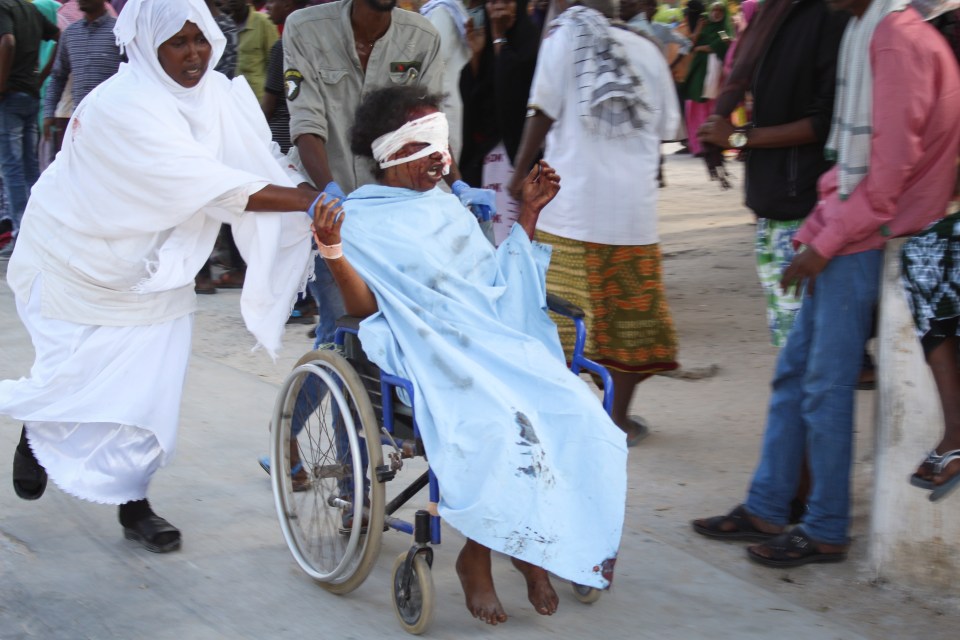  An injured woman is transported in a wheelchair to nearby Medina hospital in Mogadishu