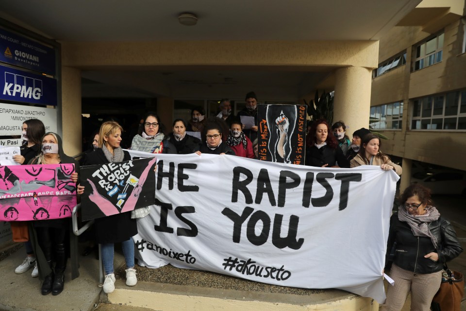 Activists protest outside the court in support of the defendant who was accused of faking a gang rape