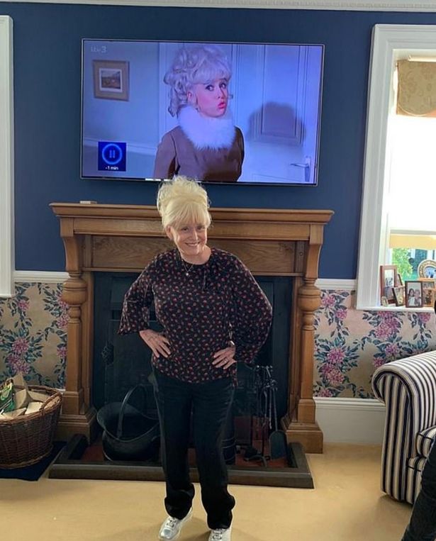  Barbara Windsor posed in front of herself in a Carry On film