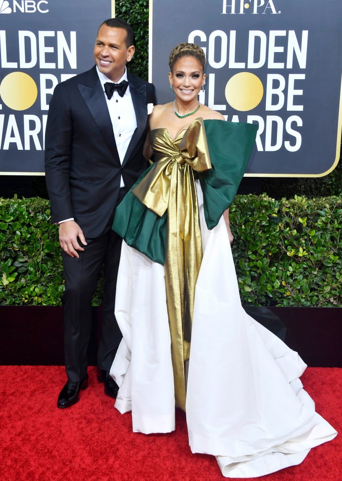  Never one to shy away on a red carpet, Jennifer Lopez looked sensational in a white, green and gold dress with an enormous bow 