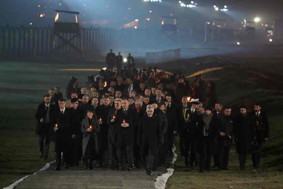  Dignitaries arrive to pay their respects as they walk ahead of survivors at the Nazi death camp