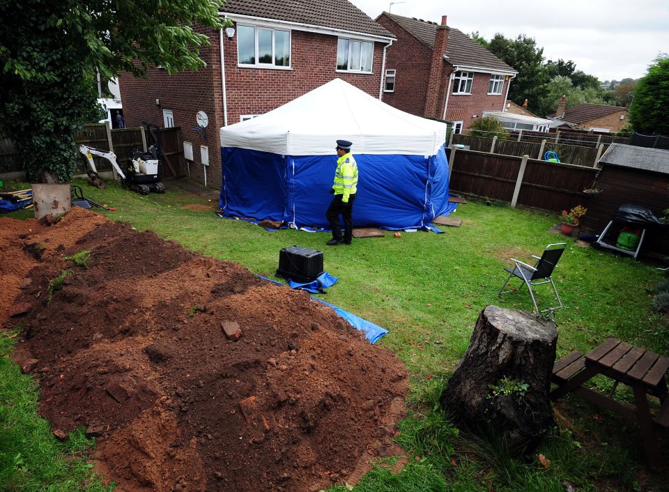  Cops work at the scene of the grisly murder to dig up the bodies of the elderly couple