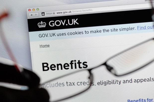 a pair of glasses sits in front of a gov.uk website