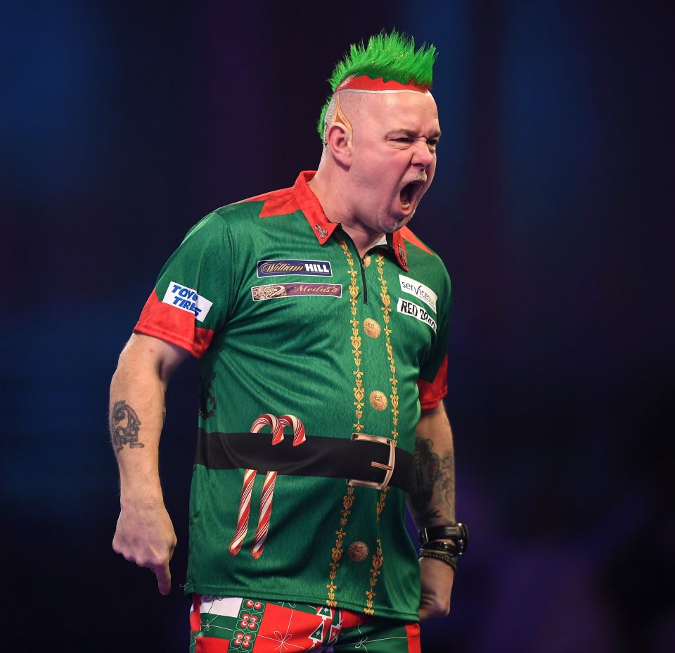  Peter Wright proved he could pull off green hair when he beat Noel Malicdem