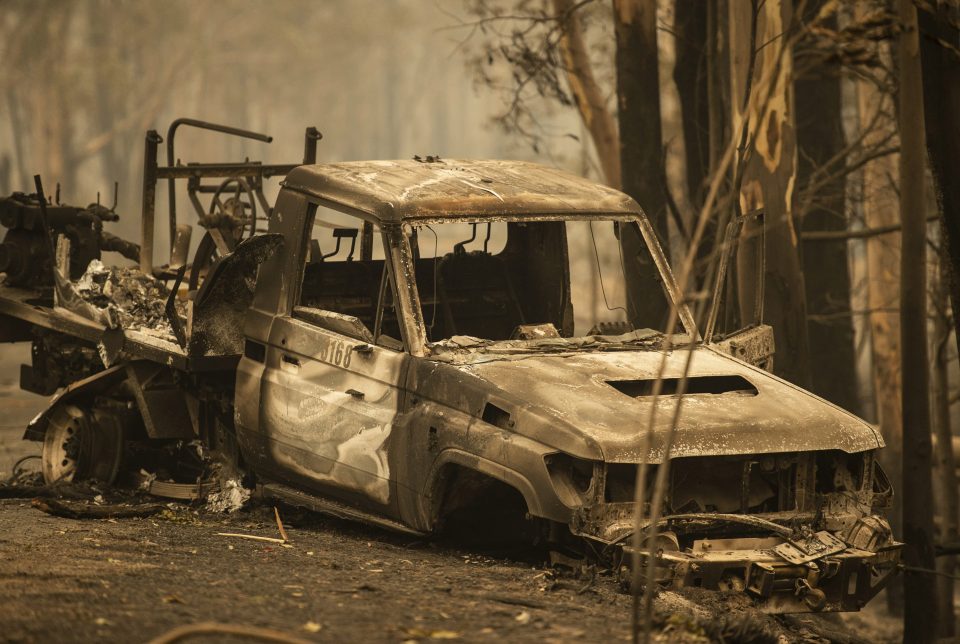 A NPWS firefighting Landcruiser lies burnt on Tallowa Dam Rd in Kangaroo Valley