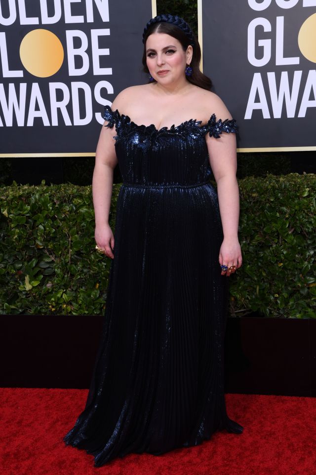 Booksmart actress Beanie Feldstein looked sensational in a navy gown with off-shoulder detail and matching satin headband