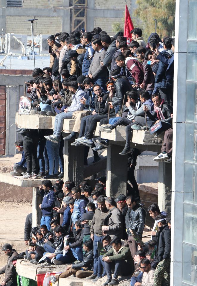  People perched on walls or any other vantage point to get a view of the procession