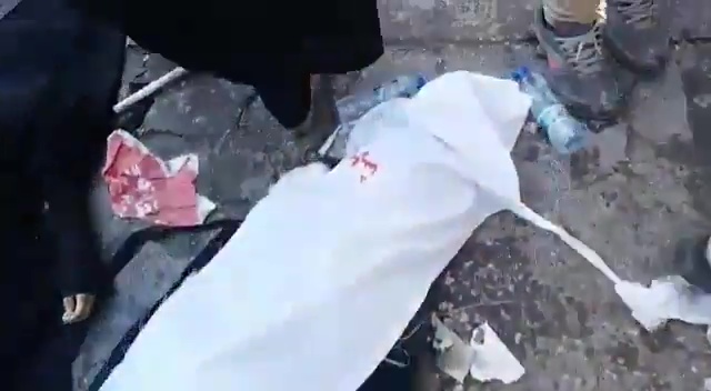  Some bodies are seen on the floor covered with sheets or blankets