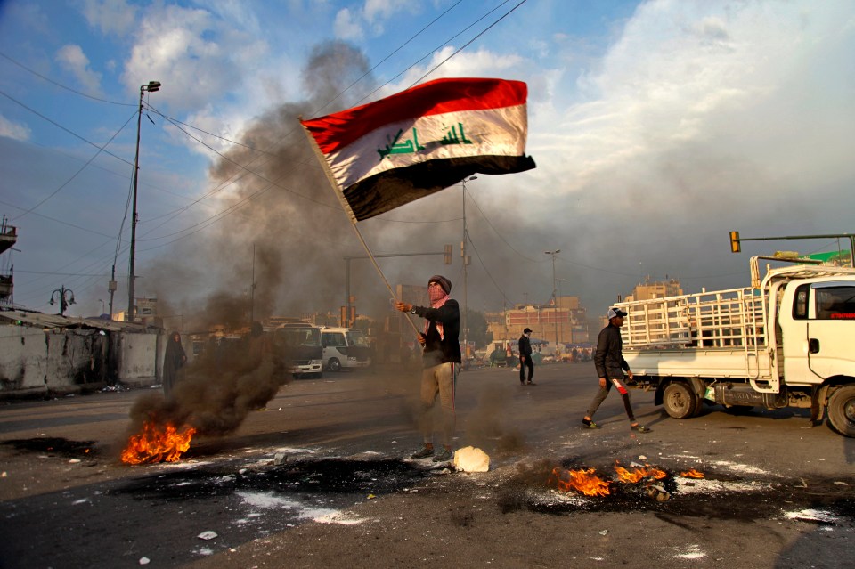  Protesters set fire to streets near Tahrir Square during a demonstration against the American drone strike