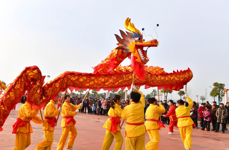 People perform a dragon dance during a gala celebrating the upcoming Chinese New Year