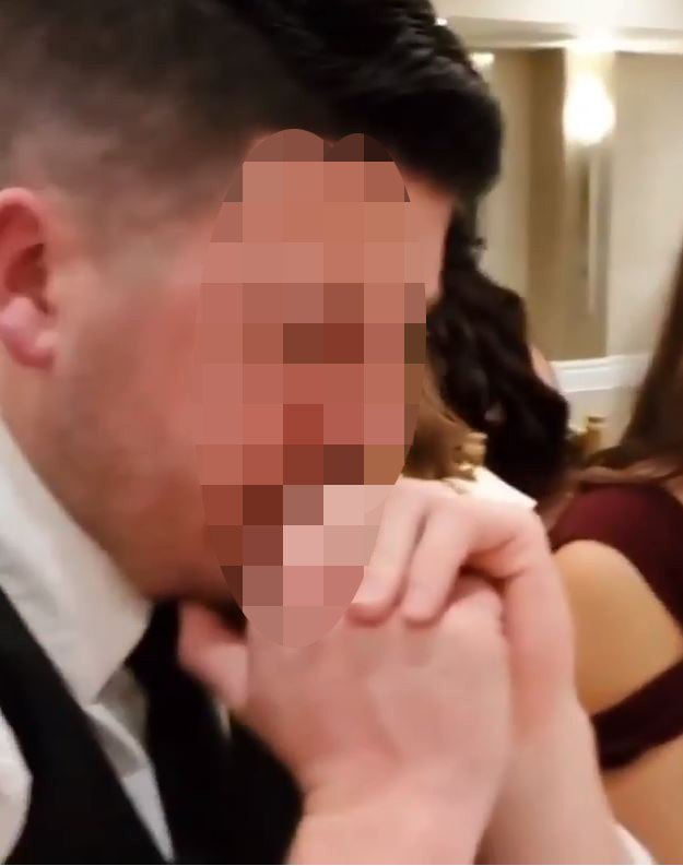 A wedding guest has been slammed online after he was spotted watching the football during the bride and groom's first dance