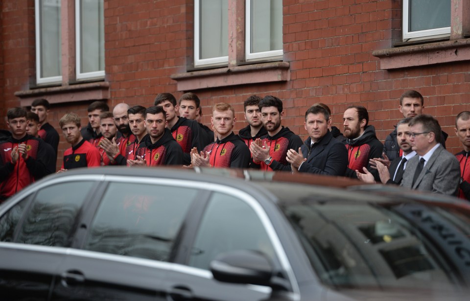  Partick Thistle players watch the procession this morning