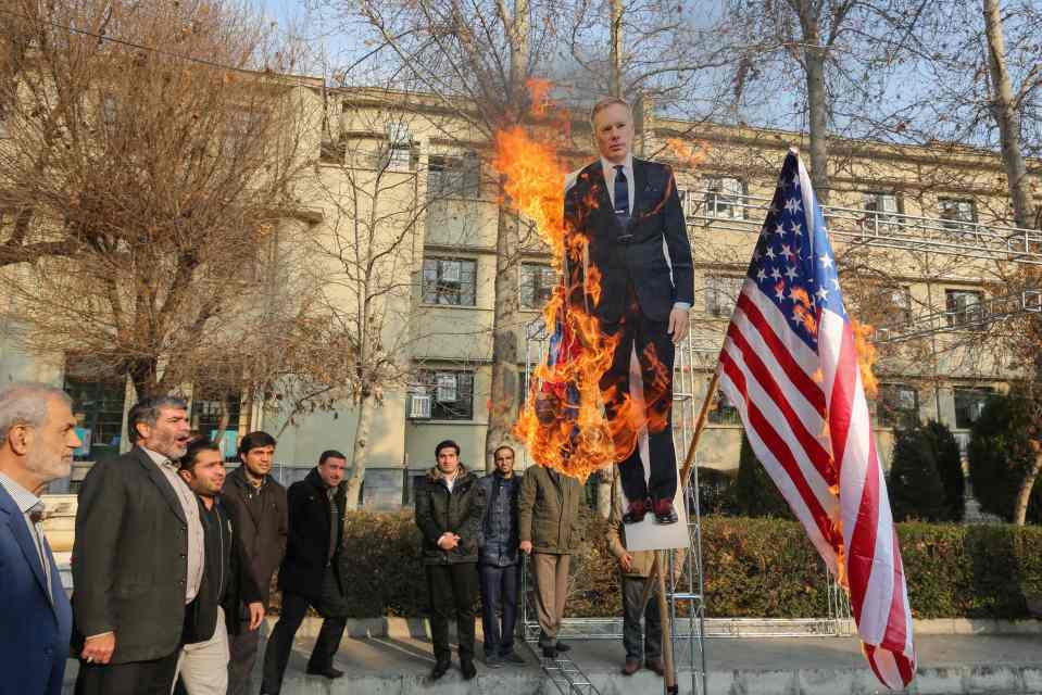  Pro-regime protesters burn a cutout of UK ambassador Rob Macaire in Tehran today