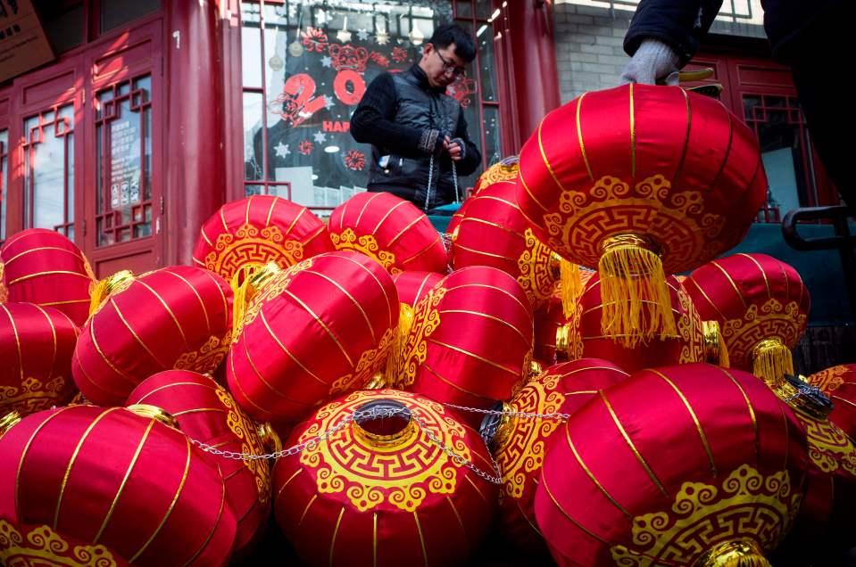  Workers prepare Chinese lanterns along a street in Beijing