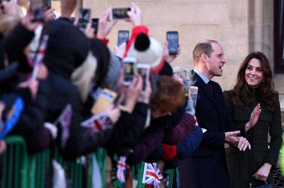  Eager royal fans lean out to get a snap of the couple