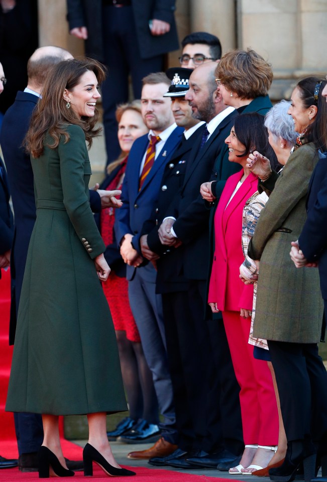  Kate laughs as she stands with husband William outside the city's town hall