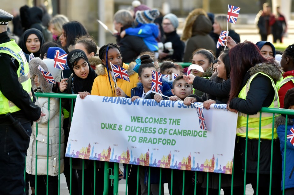  Eager royal fans hold welcoming signs for the duke and duchess