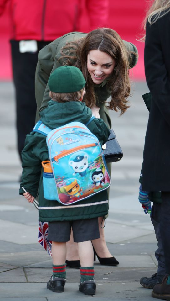  Kate grinned as she bent down to meet a little boy with a colourful backpack