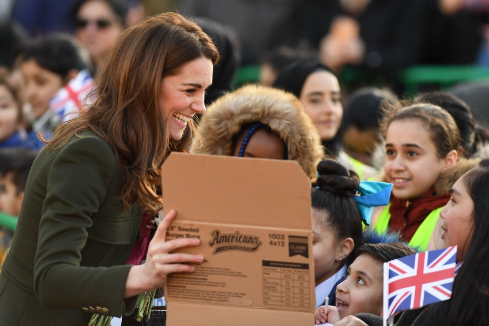  She laughed with well-wishes as she looked at a poster they had made