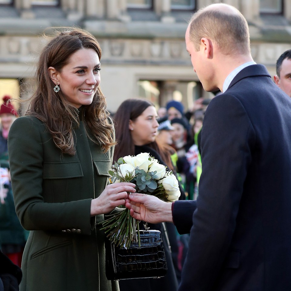  William hands Kate a rose which dropped to the ground from her bouquet