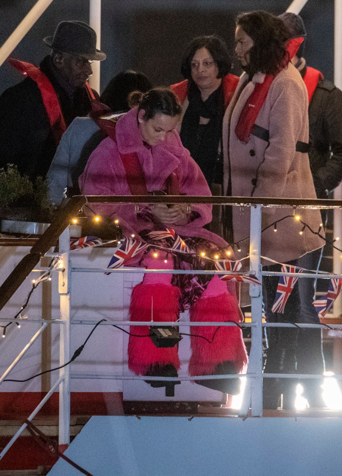  Tina straps on a life vest as she sits on the boat