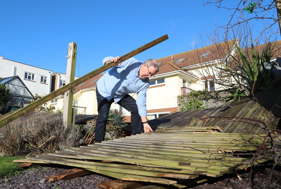  Dave Thorne with a smashed garden fence after the weather event overnight