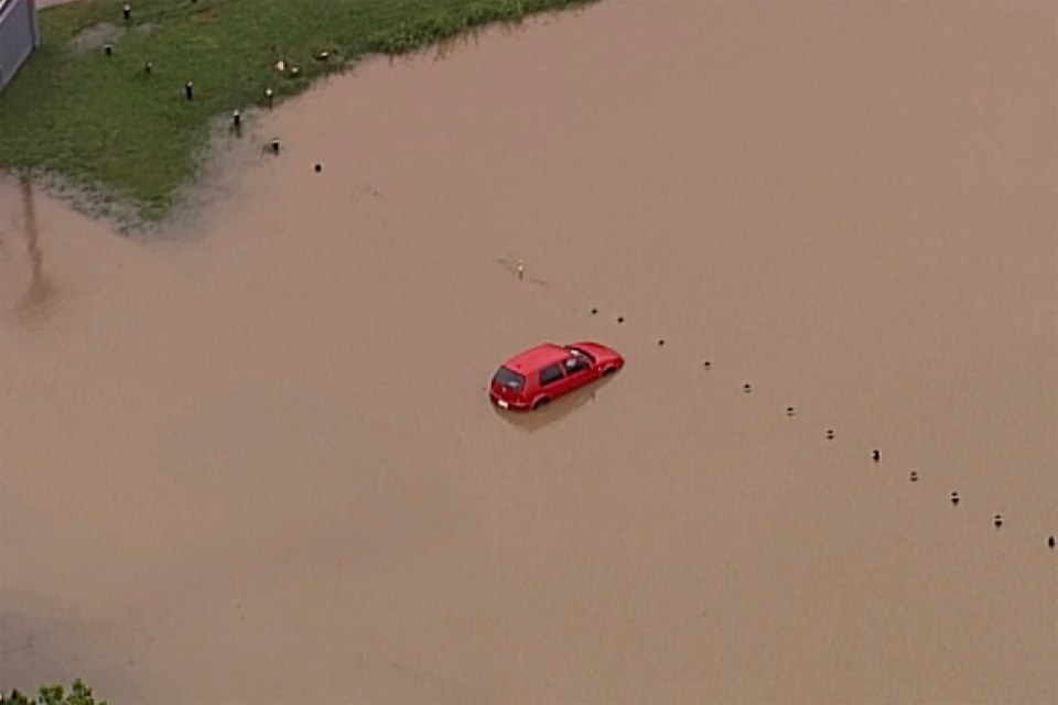  A partially submerged car is seen from above on Gold Coast, Australia