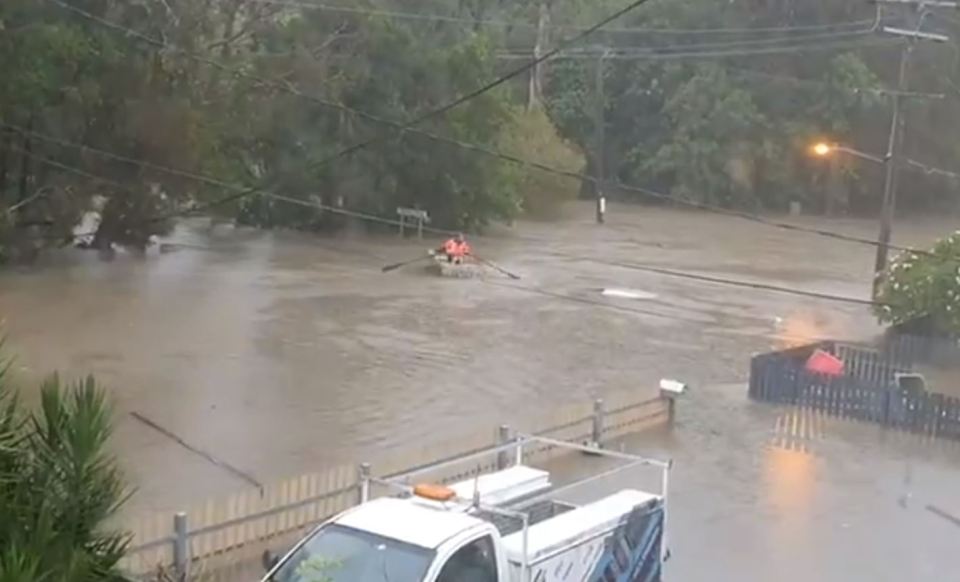  A man goes down the street in a boat after severe flooding