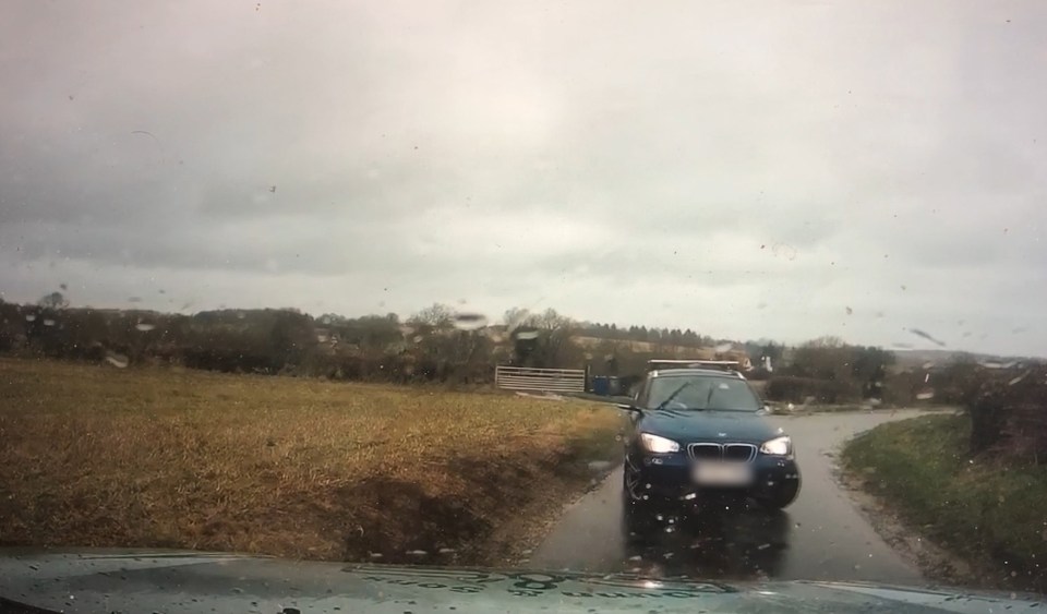  The US car narrowly misses a head-on collision as it veers to the proper side of the road