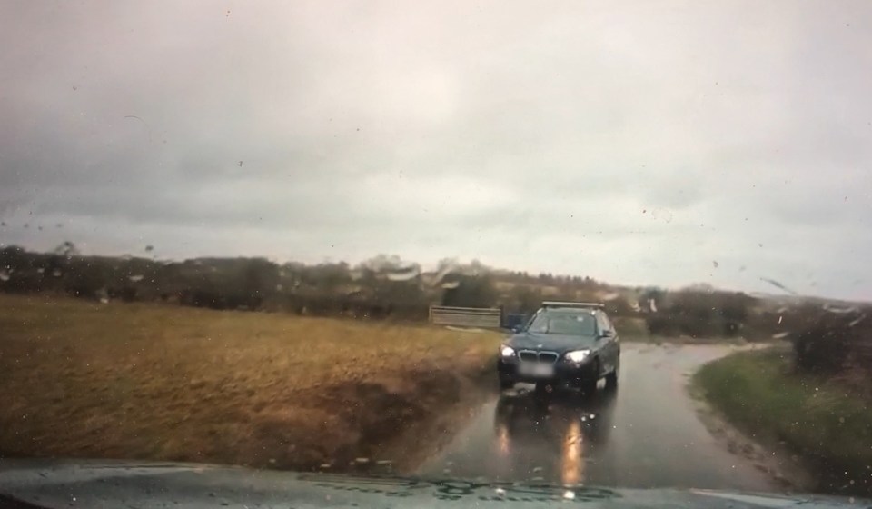  The big BMW SUV doesn't seem to notice the oncoming vehicle until it's almost too late