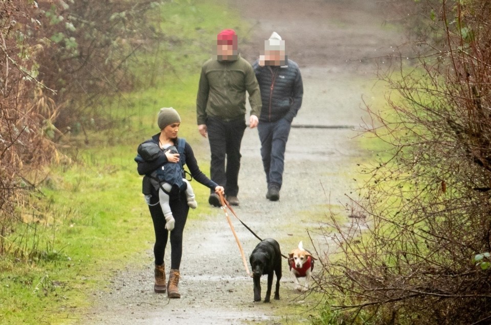  Meghan Markle also had a British police protection officer, pictured in the red hat, when she went walking with Archie