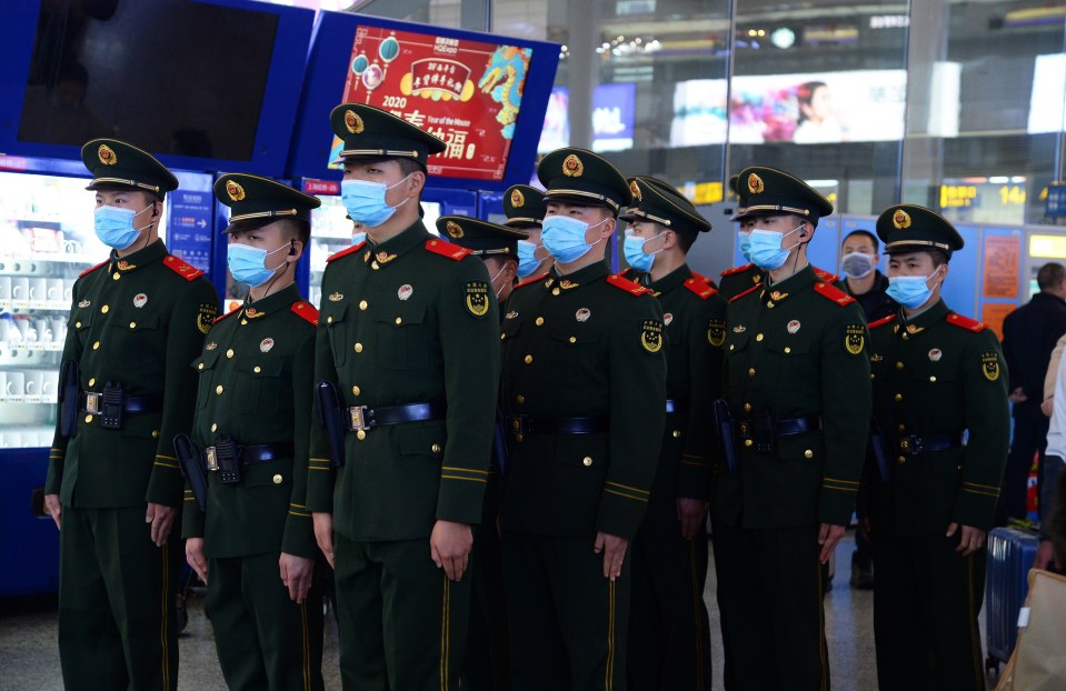  Chinese paramilitary police officers wearing masks patrol the Hongqiao Railway Station in Shanghai