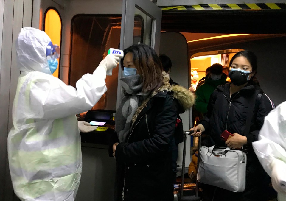  Pictures show medics screening passengers on a plane to Macao from Wuhan