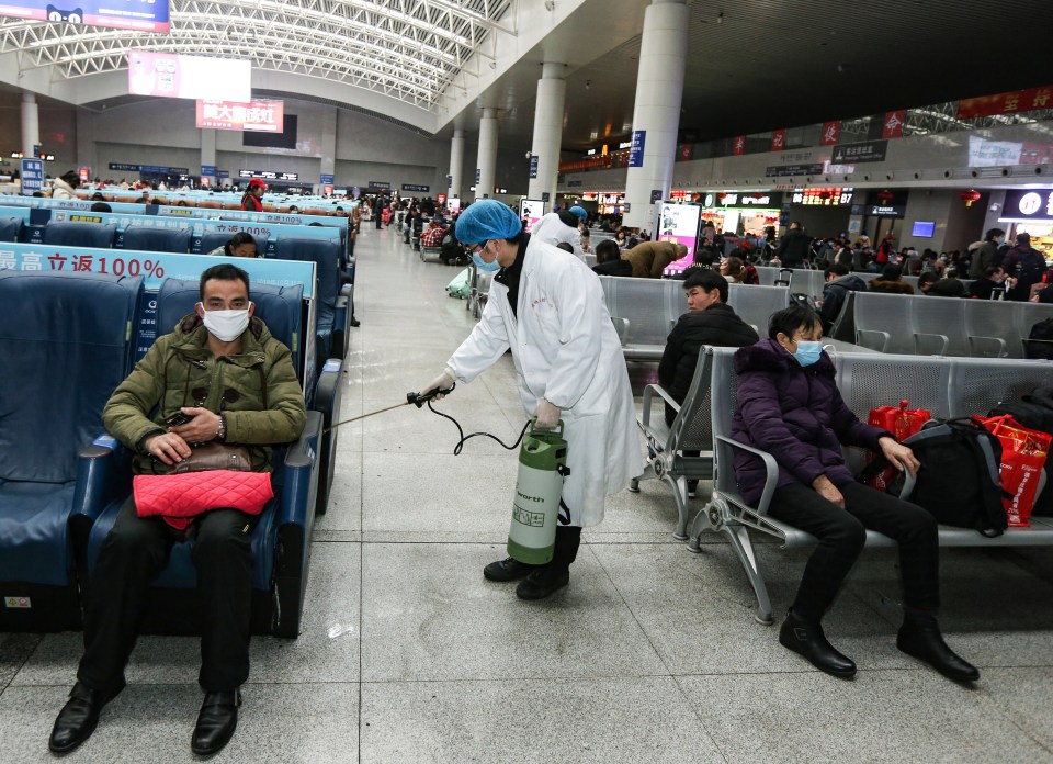 worker disinfects a railway station in China after a virus has infected more than 500 people in the country