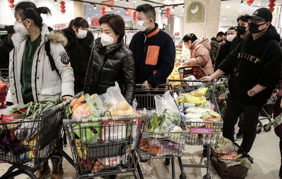 Wuhan residents wearing masks as they stockpile on food amid the virus outbreak