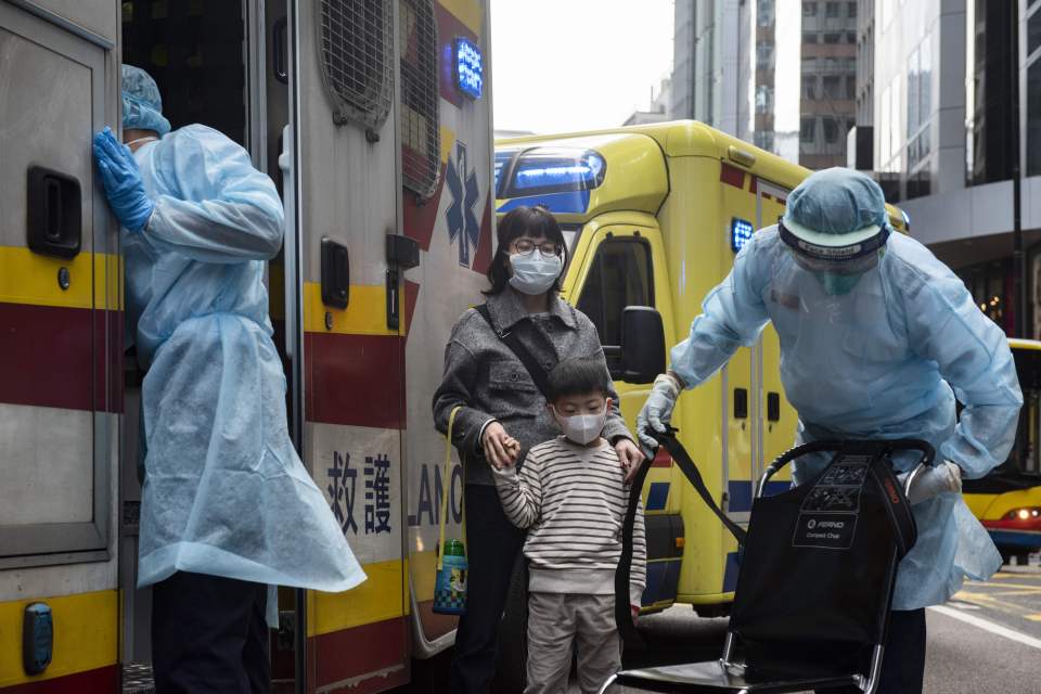  A little boy and a woman wearing sanitary masks in Hong Kong