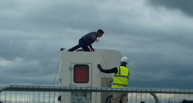  Knox is seen talking to a construction worker who is trying to coax him down from the lorry